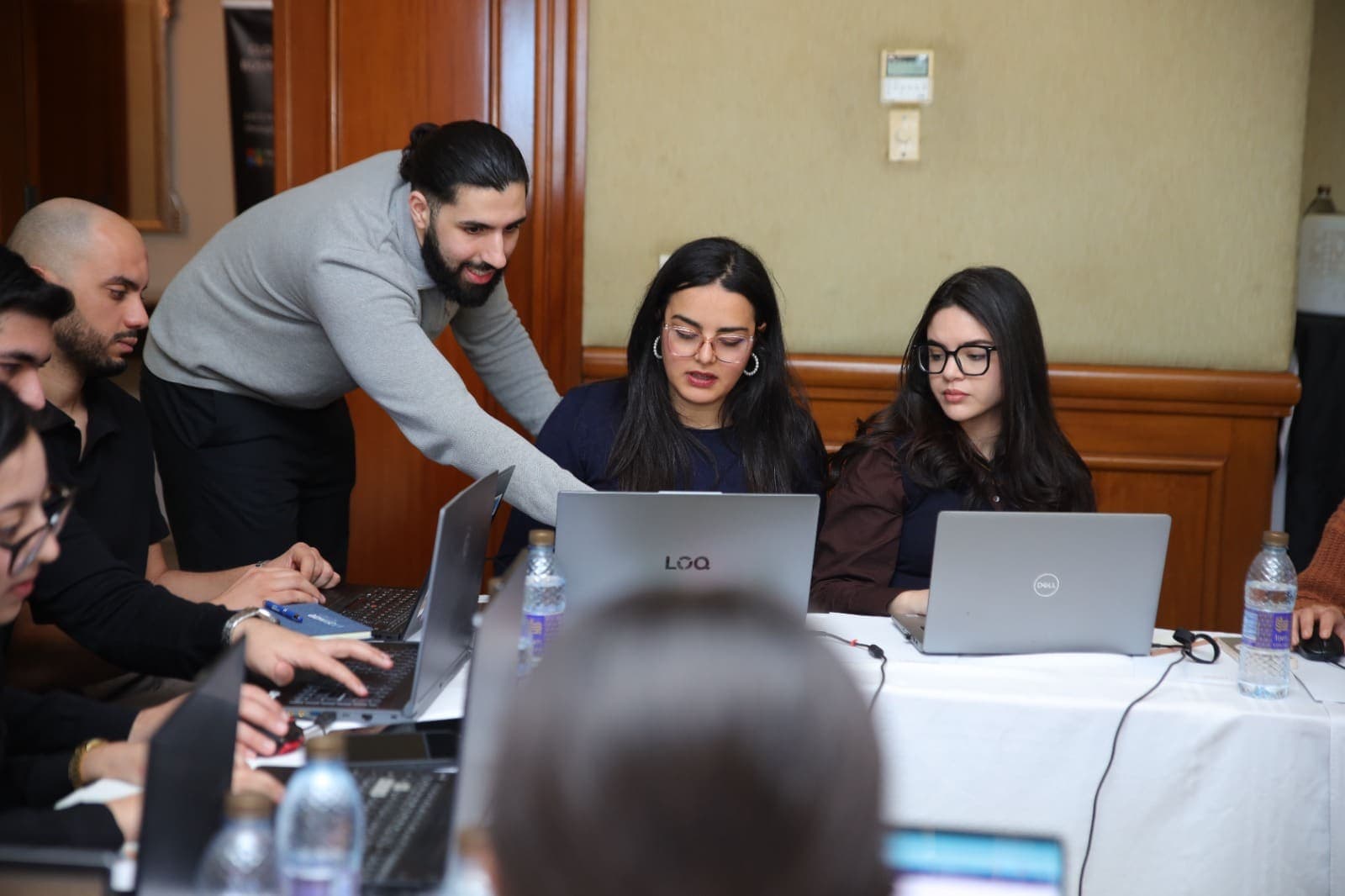 Howdang Rashid working through a build at a delegate's laptop during a hands-on session